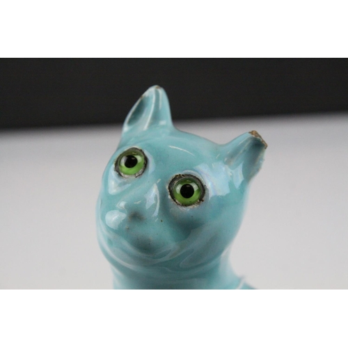 28 - In the manner of Galle, A Mosanic Pottery Seated Cat, glazed in yellow with blue painted hearts and ... 