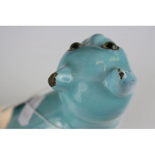 28 - In the manner of Galle, A Mosanic Pottery Seated Cat, glazed in yellow with blue painted hearts and ... 