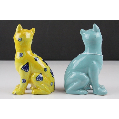 28 - In the manner of Galle, A Mosanic Pottery Seated Cat, glazed in yellow with blue painted hearts and ... 
