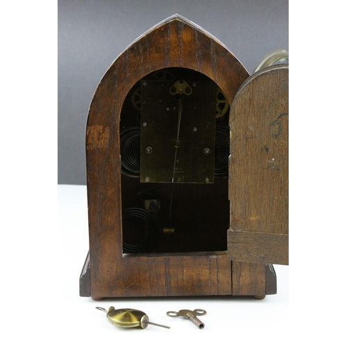 53 - Early 20th century 8 Day Mantle Clock contained in an Oak Arched Case with Brass Face, 30cms high