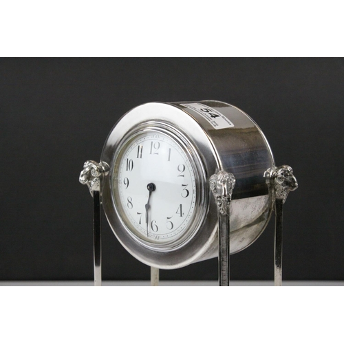 54 - French Empire Style Mantle Clock contained within a Silver Plated Case raised on square pillar suppo... 