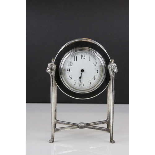 54 - French Empire Style Mantle Clock contained within a Silver Plated Case raised on square pillar suppo... 