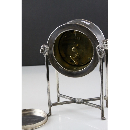 54 - French Empire Style Mantle Clock contained within a Silver Plated Case raised on square pillar suppo... 