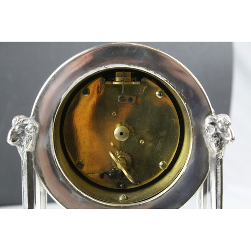 54 - French Empire Style Mantle Clock contained within a Silver Plated Case raised on square pillar suppo... 
