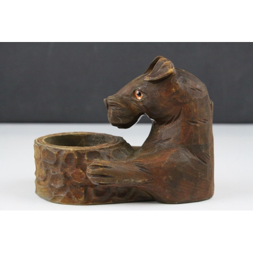 58 - A black Forest style dog matchbox holder and ashtray with glass eyes.