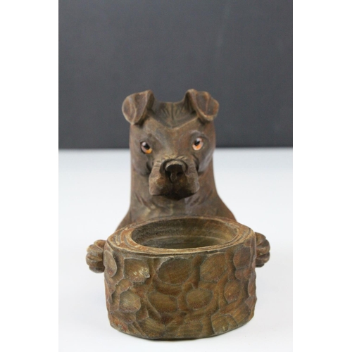 58 - A black Forest style dog matchbox holder and ashtray with glass eyes.