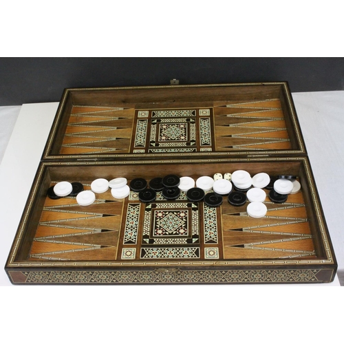 110 - Two Wooden Games Boxes inlaid with bone and mother of pearl, each containing draughts pieces and dic... 