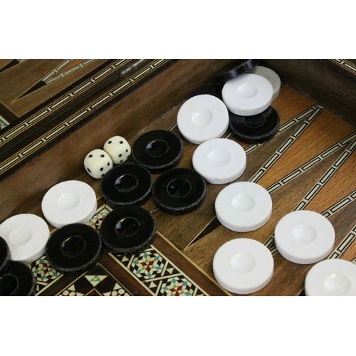 110 - Two Wooden Games Boxes inlaid with bone and mother of pearl, each containing draughts pieces and dic... 