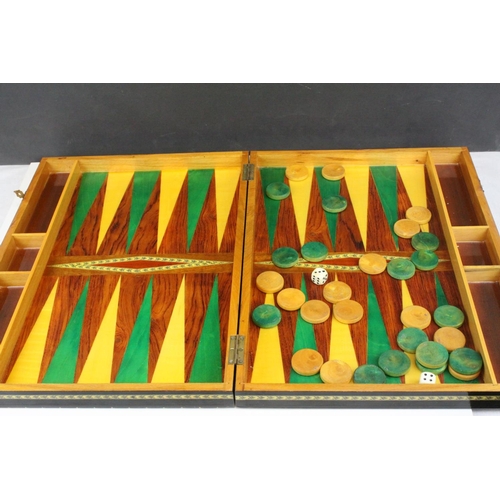 110 - Two Wooden Games Boxes inlaid with bone and mother of pearl, each containing draughts pieces and dic... 