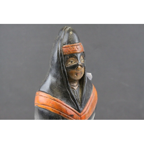 118 - Carved Wooden Figure of a Masked Person wearing a Hood Cape, possibly South American, 29cms high