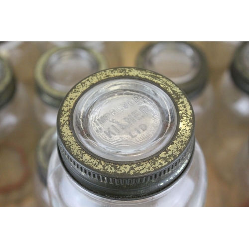 79 - Twelve Mid 20th century Kilner Jars with screw-on lids, 18cms high