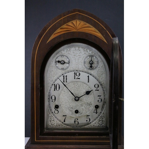 97 - Edwardian Mahogany Inlaid Arched Top Three Train Mantle Clock, the engraved white metal face with Fa... 