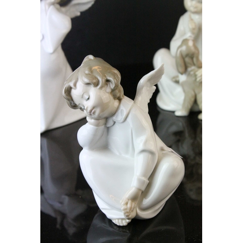 129 - Four Lladro Figures including ' Shh Quiet Puppy ' model no. 4522 and Three Angel Figures