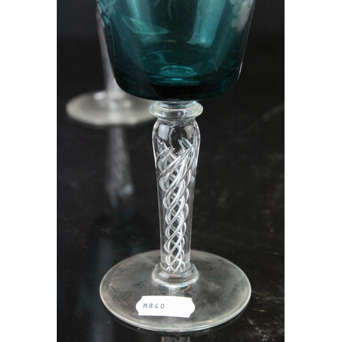 130 - Set of Four Blue Wine Goblets, etched with grapes and vines, raised on clear air twist stems, 20cms ... 