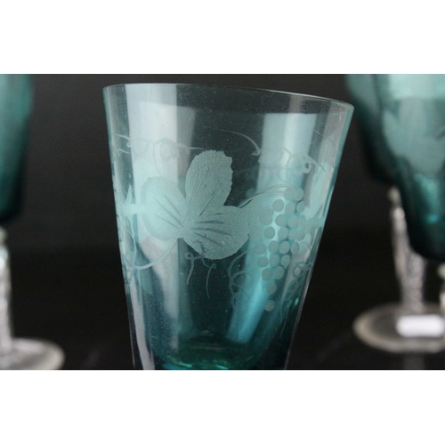 130 - Set of Four Blue Wine Goblets, etched with grapes and vines, raised on clear air twist stems, 20cms ... 