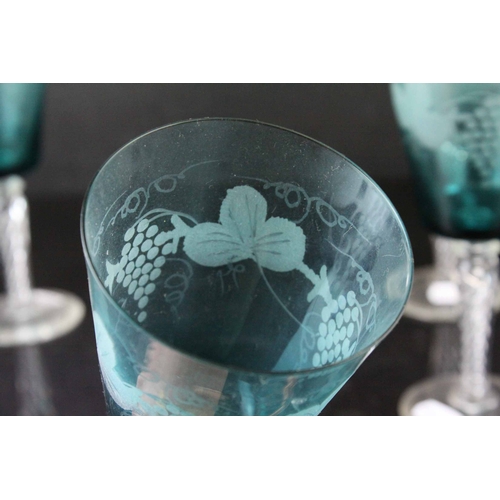 130 - Set of Four Blue Wine Goblets, etched with grapes and vines, raised on clear air twist stems, 20cms ... 