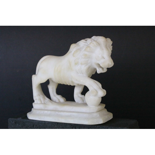 141 - Pair of Carved Alabaster Lions holding a Ball under their front paw, 15cms long