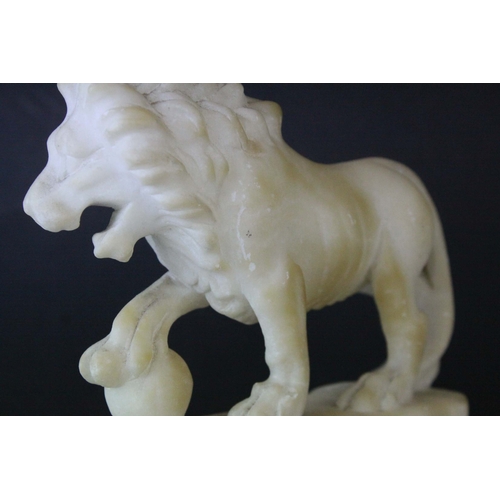 141 - Pair of Carved Alabaster Lions holding a Ball under their front paw, 15cms long