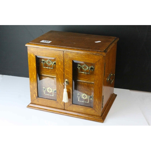 159 - Late 19th century Oak Table Top Cabinet, the two glazed doors opening to reveal drawers with brass h... 