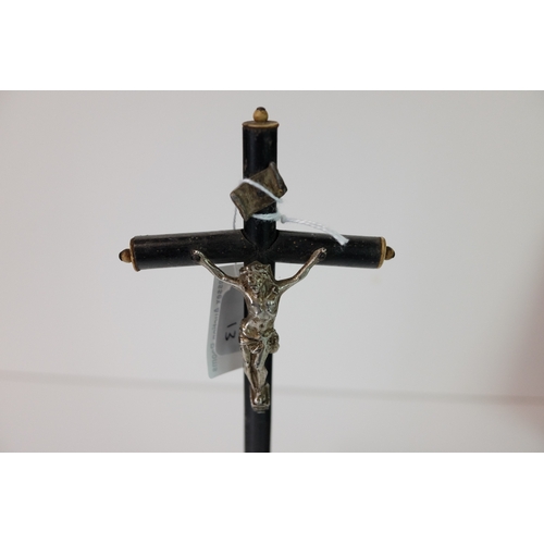 175 - Wooden Ebonised Crucifix mounted with a White Metal Christ and raised on a plinth base, 19.5cms high... 