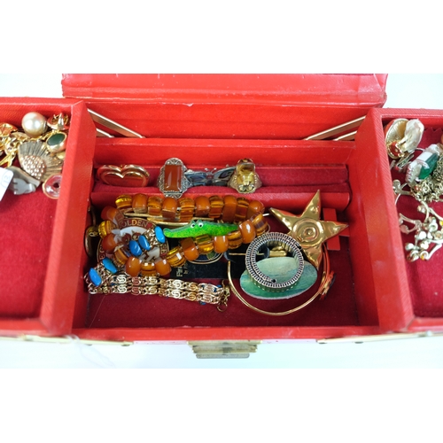 203 - Costume Jewllery including earrings, bracelets in a cantilevered red leather jewellery case