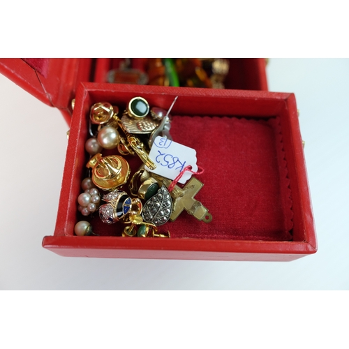 203 - Costume Jewllery including earrings, bracelets in a cantilevered red leather jewellery case