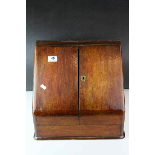 49 - Victorian Oak Stationery Cabinet, the sloping front with two doors opening to reveal a fitted interi... 