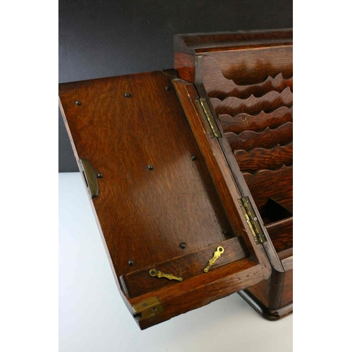 49 - Victorian Oak Stationery Cabinet, the sloping front with two doors opening to reveal a fitted interi... 