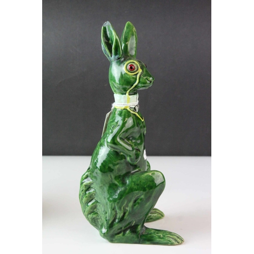 7 - Two Early 20th century Pottery Models of Seated Hares, one white glazed and the other green glazed, ... 