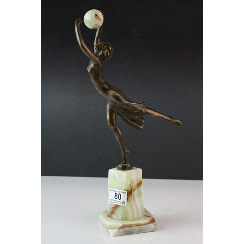 80 - Bronze Effect Art Deco Style Figurine holding an Onyx Ball and stood on an Onyx Plinth, 36cms high