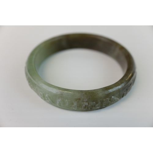 230 - Spinach Jade Bangle with carved design to outer rim, 9cms diameter