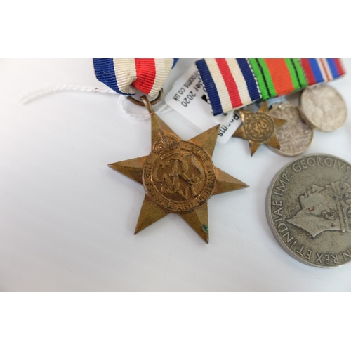 241 - Two World War II Medals together with a Bar holding Three Miniature World War II Medals