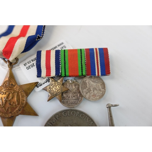 241 - Two World War II Medals together with a Bar holding Three Miniature World War II Medals