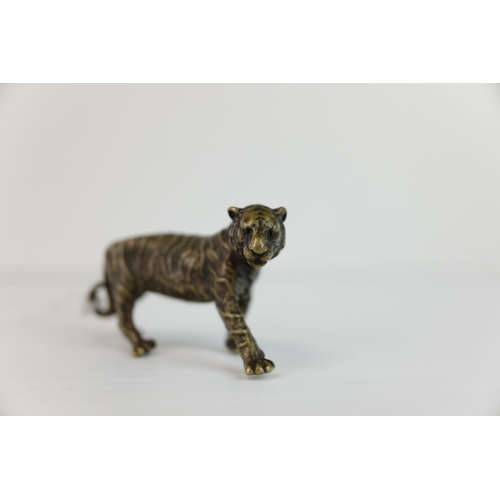 283 - A brass/bronze figure of a tiger.