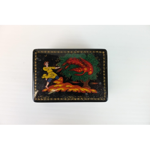 296 - Four Russian Black Lacquered Trinket Boxes, each with painted design to lid, largest 8cms long