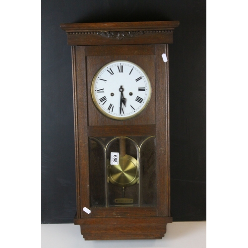 688 - Early 20th century Oak Cased Eight Day Hanging Wall Clock, the white enamel face with arabic numeral... 