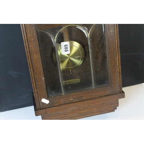 688 - Early 20th century Oak Cased Eight Day Hanging Wall Clock, the white enamel face with arabic numeral... 