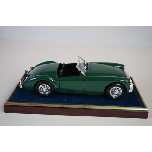 1171 - Five cased 1:18 scale diecast model classic cars, to include MG, Ferrari, Bugatti, Aston Martin & Me... 