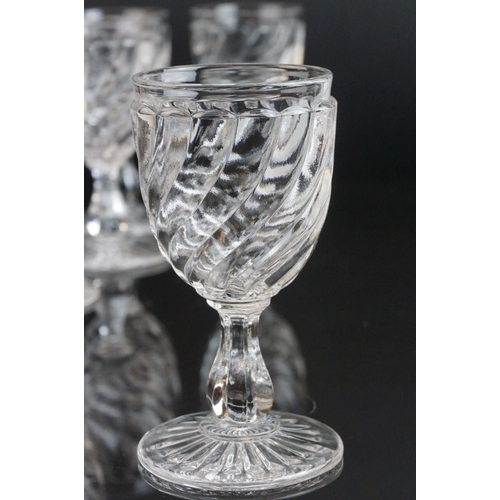 146 - Part suite of moulded and cut glass port and wine glasses, the bowls with spiral decoration (nine wi... 
