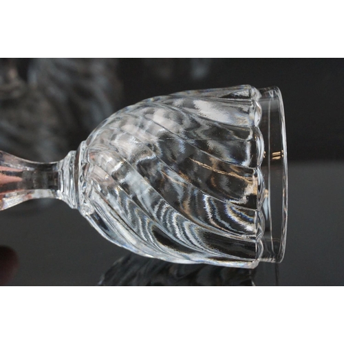 146 - Part suite of moulded and cut glass port and wine glasses, the bowls with spiral decoration (nine wi... 