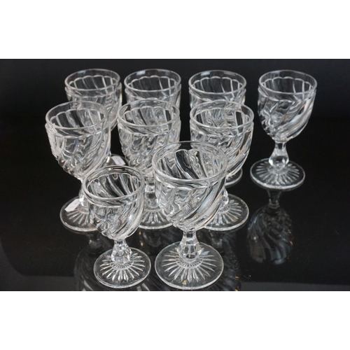 146 - Part suite of moulded and cut glass port and wine glasses, the bowls with spiral decoration (nine wi... 