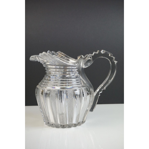 149 - Three late 18th/ early 19th Century Anglo-Irish glass water jugs, with various hobnail and cross hat... 