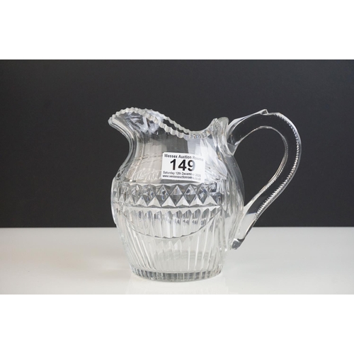 149 - Three late 18th/ early 19th Century Anglo-Irish glass water jugs, with various hobnail and cross hat... 
