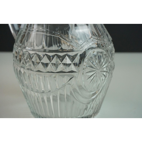 149 - Three late 18th/ early 19th Century Anglo-Irish glass water jugs, with various hobnail and cross hat... 