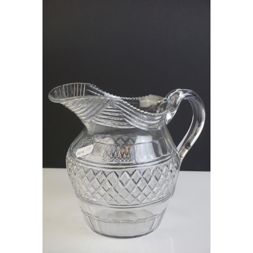 149 - Three late 18th/ early 19th Century Anglo-Irish glass water jugs, with various hobnail and cross hat... 