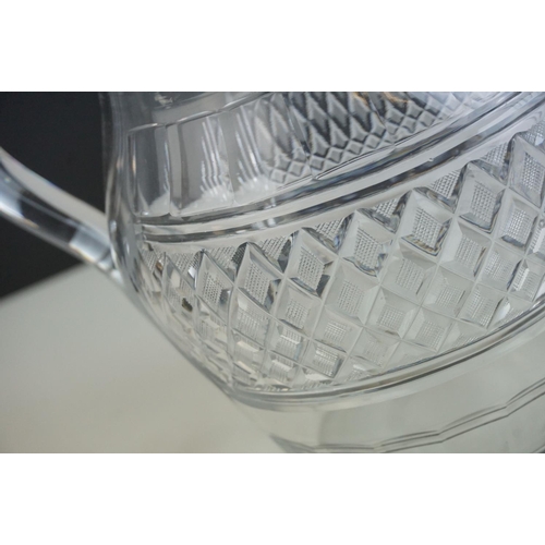 149 - Three late 18th/ early 19th Century Anglo-Irish glass water jugs, with various hobnail and cross hat... 