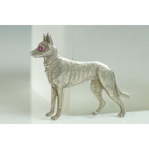 166 - Sterling Silver Brooch in the form of a German Shepherd Dog with cabouchon ruby eye, 4cms long