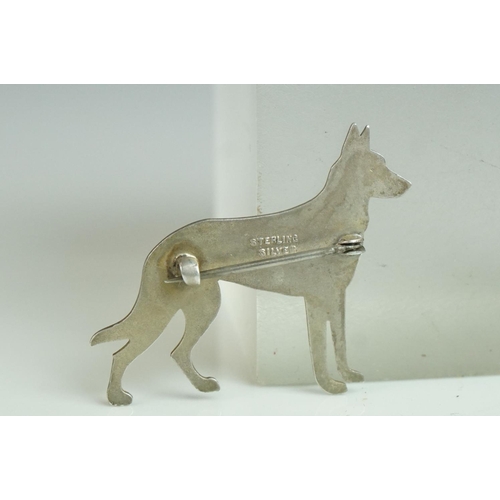 166 - Sterling Silver Brooch in the form of a German Shepherd Dog with cabouchon ruby eye, 4cms long