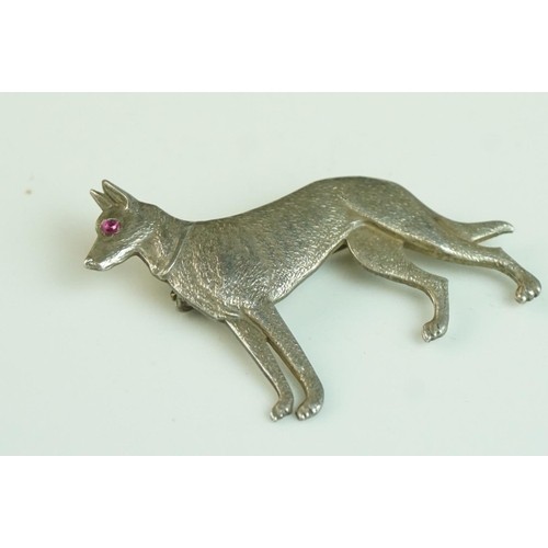 166 - Sterling Silver Brooch in the form of a German Shepherd Dog with cabouchon ruby eye, 4cms long