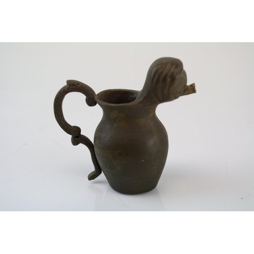 192 - A small bronze miniature drinking vessel.